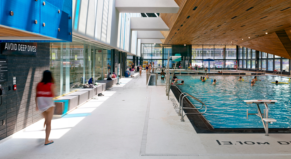 People swimming in the indoor lap and leisure pool at the Regent Park Aquatic Centre
